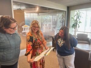 Lauren Jasinski chatting with two teachers from the summer collaborative team